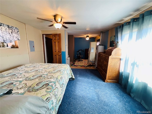 bedroom featuring multiple windows, a ceiling fan, dark carpet, and radiator heating unit