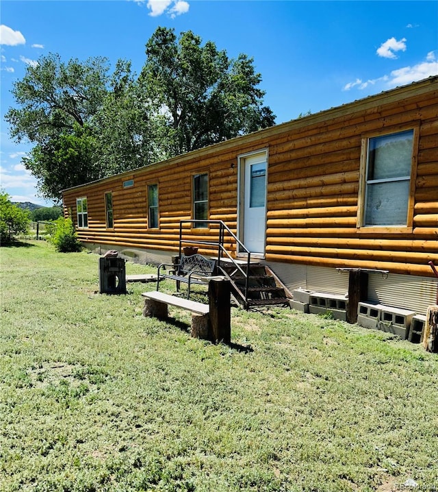 log-style house with a front lawn