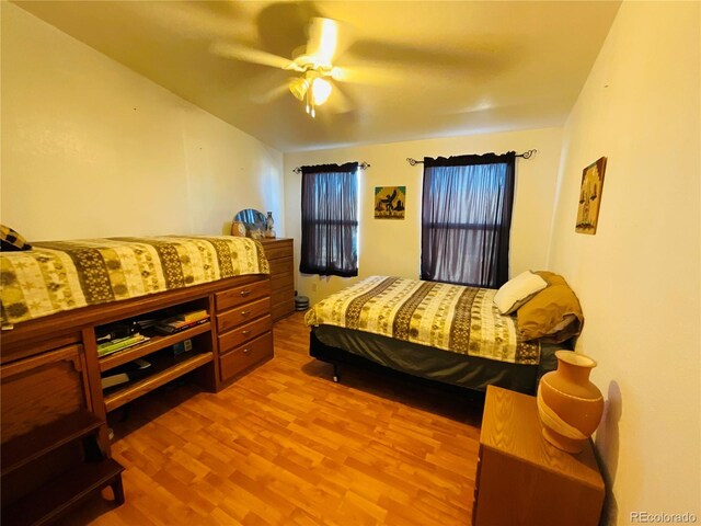 bedroom with wood finished floors and a ceiling fan