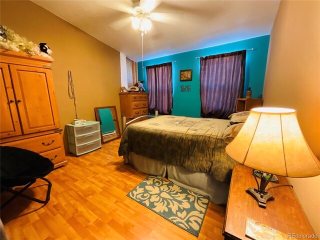 bedroom with light wood-style flooring and ceiling fan