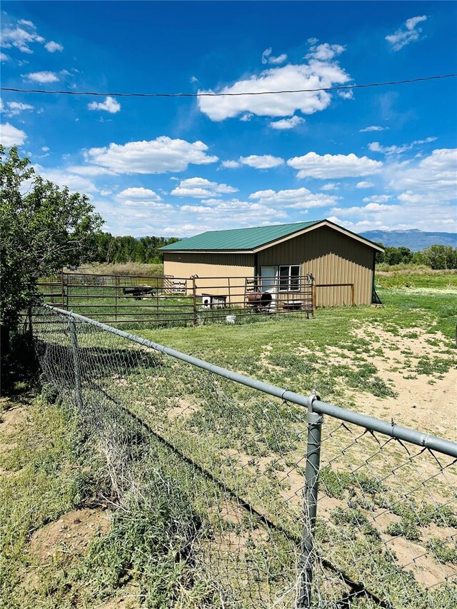 view of horse barn with a rural view