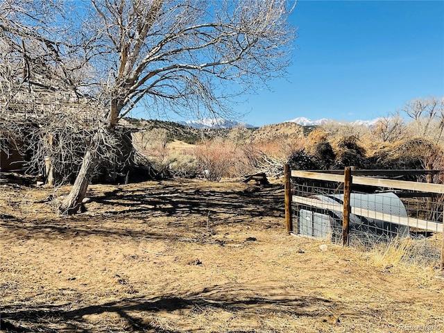 view of yard with a mountain view and fence