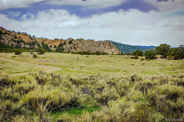 property view of mountains featuring a rural view