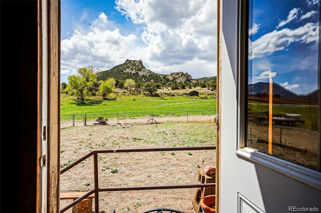 entryway with a rural view and a mountain view