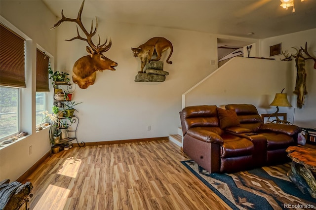 living area with baseboards and wood finished floors