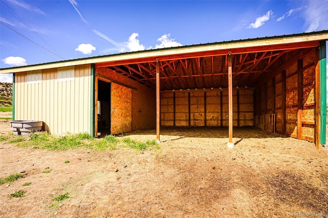 view of outbuilding featuring a carport, an outbuilding, and an exterior structure