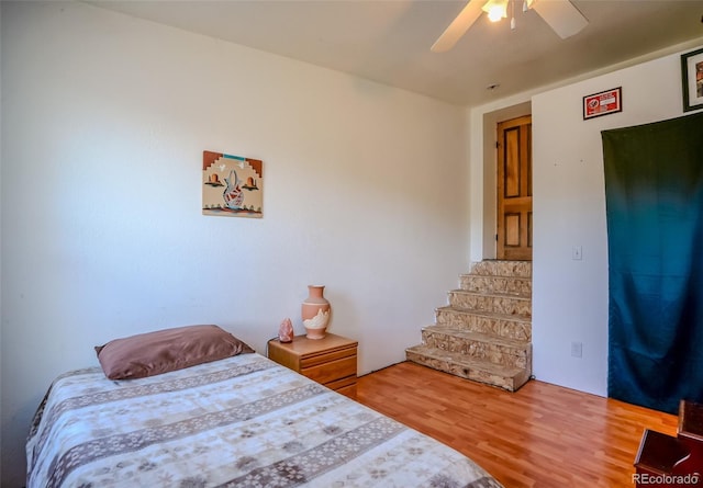 bedroom featuring a ceiling fan and wood finished floors