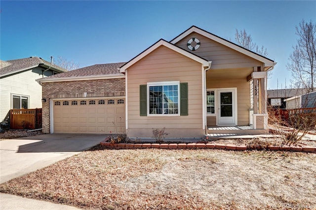 view of front of home with brick siding, a shingled roof, concrete driveway, covered porch, and a garage