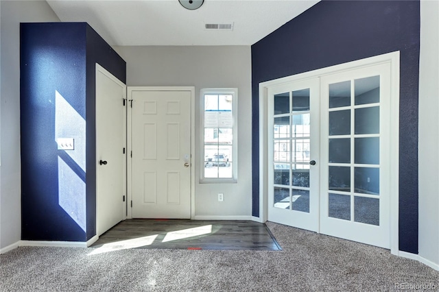 entrance foyer with visible vents, baseboards, carpet, and french doors