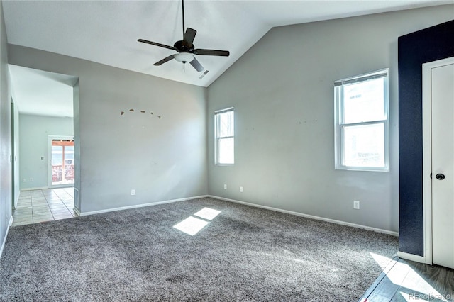 interior space featuring baseboards, lofted ceiling, ceiling fan, and carpet flooring