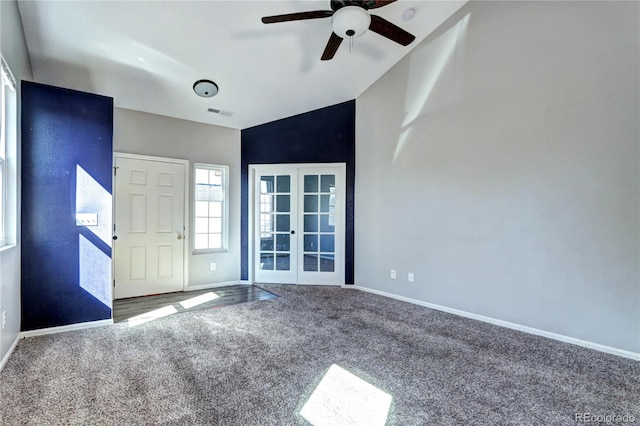 carpeted entrance foyer featuring visible vents, baseboards, lofted ceiling, french doors, and a ceiling fan