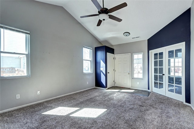 carpeted spare room with a ceiling fan, baseboards, visible vents, high vaulted ceiling, and french doors