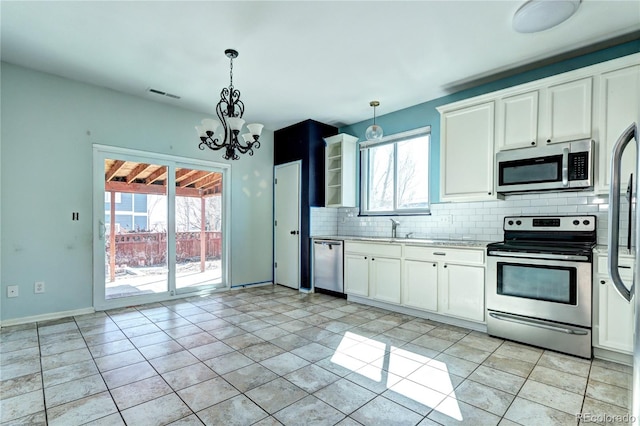 kitchen featuring visible vents, light countertops, decorative backsplash, white cabinets, and stainless steel appliances