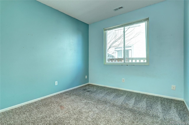 unfurnished room with baseboards, visible vents, and carpet floors