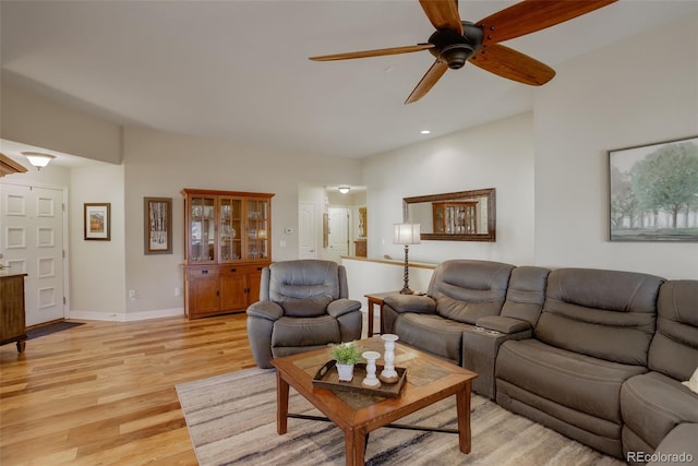 living room with light hardwood / wood-style floors and ceiling fan