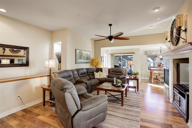 living room featuring ceiling fan and light wood-type flooring