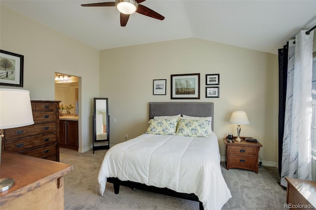 carpeted bedroom with ceiling fan, ensuite bath, and lofted ceiling