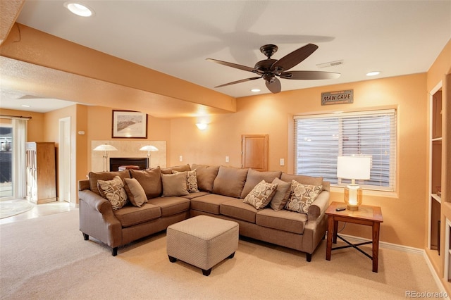 living room with light colored carpet and ceiling fan