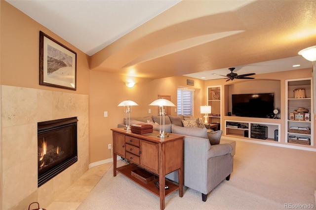 living room with light colored carpet, vaulted ceiling, built in features, and a premium fireplace