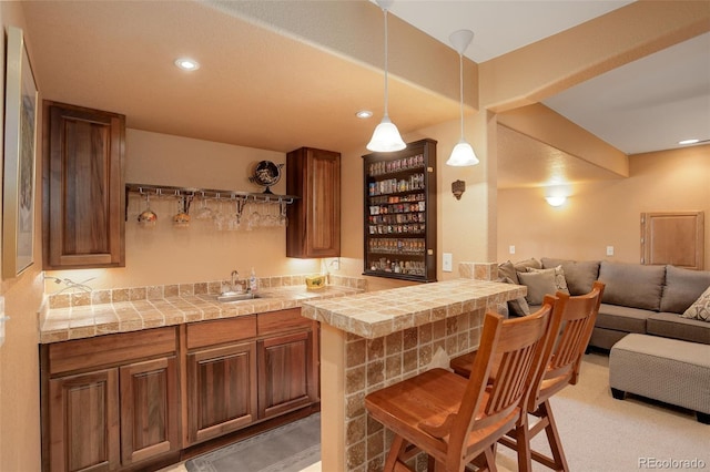 bar with sink, pendant lighting, and carpet flooring