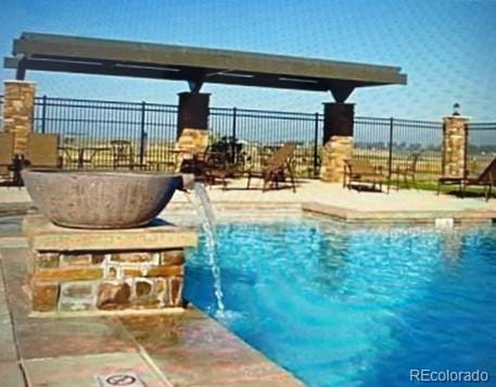 view of swimming pool featuring pool water feature and a patio area