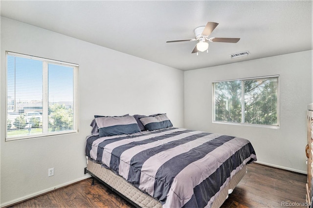 18786 E 57th Pl Unit A, Denver, CO 80249 - bedroom featuring multiple windows, dark wood-type flooring, and ceiling fan