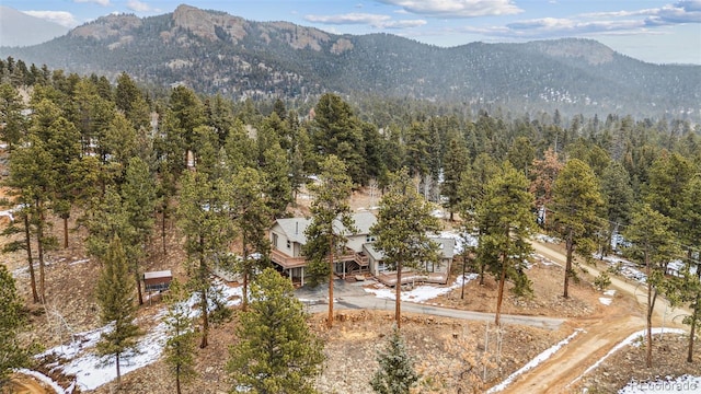 aerial view with a mountain view and a forest view