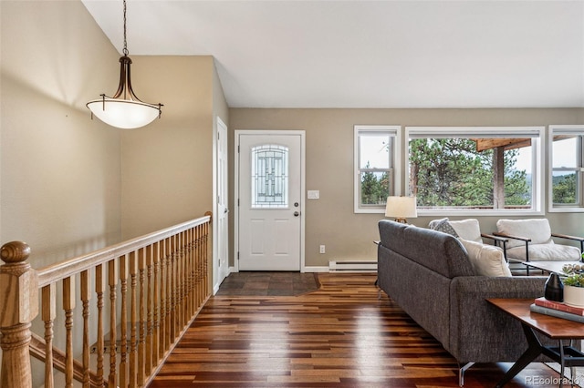 foyer entrance with a wealth of natural light, a baseboard radiator, baseboards, and wood finished floors