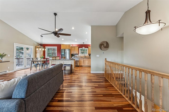 living area featuring lofted ceiling, recessed lighting, a ceiling fan, wood finished floors, and baseboards