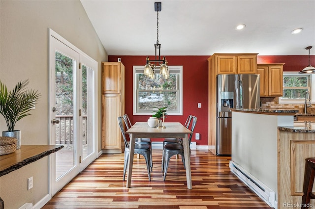 dining area featuring a baseboard heating unit, light wood finished floors, baseboards, and recessed lighting