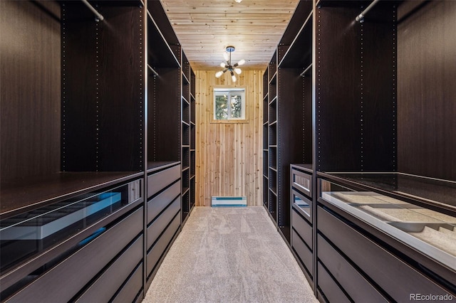 walk in closet featuring carpet and a notable chandelier