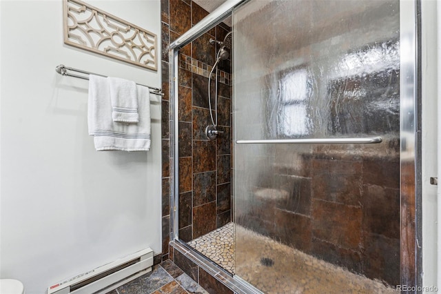 bathroom featuring a baseboard heating unit and a stall shower