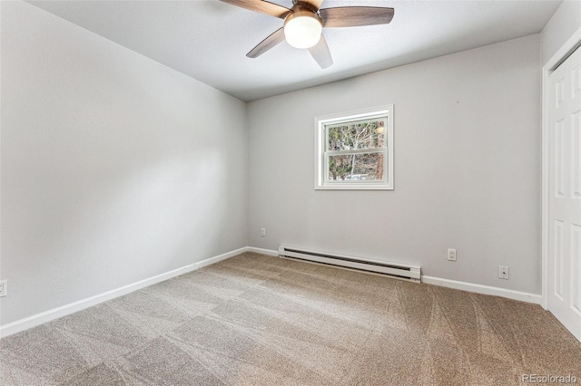 empty room with a baseboard heating unit, carpet floors, a ceiling fan, and baseboards