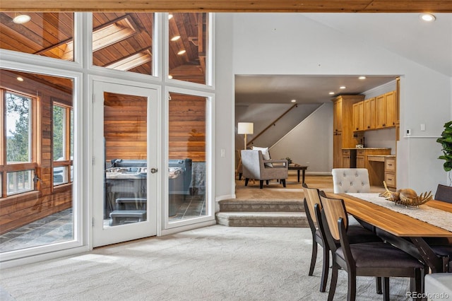 dining area featuring light carpet, high vaulted ceiling, stairs, and recessed lighting