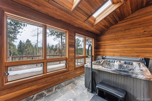 sunroom / solarium with lofted ceiling with skylight, wooden ceiling, and a jacuzzi