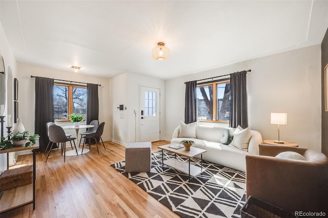 living room with light wood-style flooring and baseboards