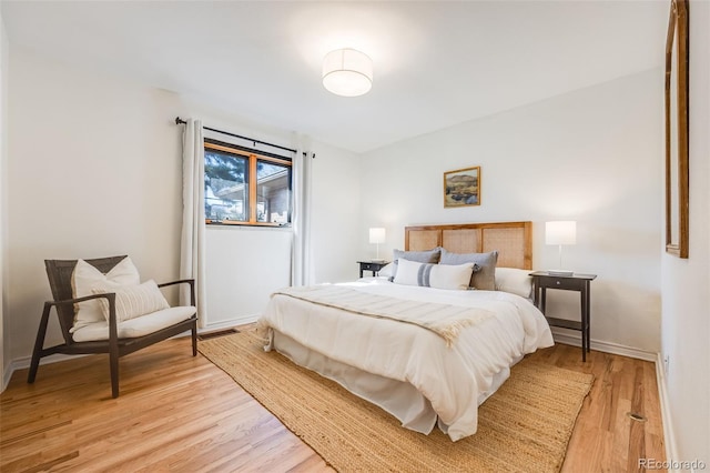 bedroom featuring light wood-style floors and baseboards