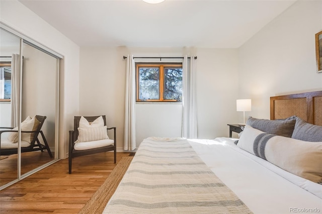 bedroom with a closet and light wood-style flooring