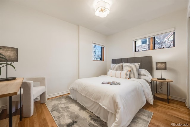 bedroom with wood finished floors and baseboards