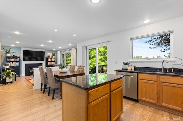 15963 Rock Crystal Dr, Parker, CO 80134 - kitchen featuring stainless steel dishwasher, a sink, light wood-style floors, recessed lighting, and a fireplace