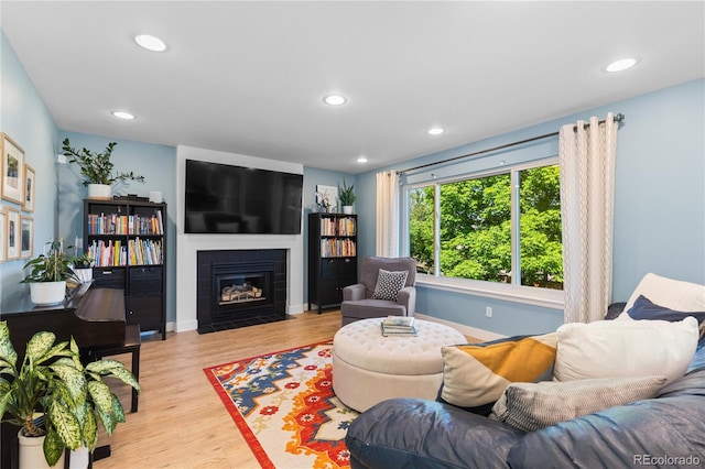 15963 Rock Crystal Dr, Parker, CO 80134 - living room with wood finished floors, recessed lighting, a fireplace with flush hearth, and baseboards