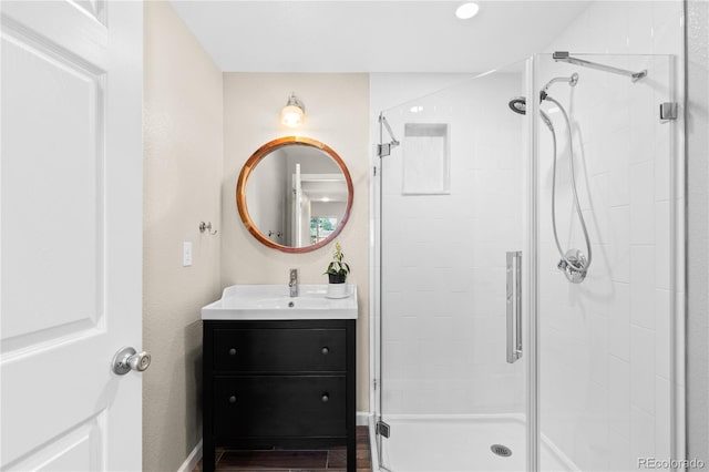 15963 Rock Crystal Dr, Parker, CO 80134 - full bathroom featuring a stall shower, vanity, wood finished floors, and baseboards