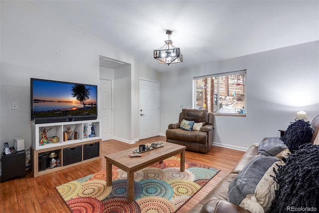 living room with a chandelier and wood-type flooring