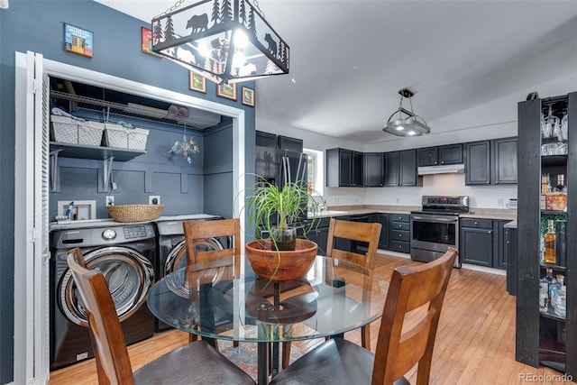 dining space featuring light wood-type flooring, lofted ceiling, and separate washer and dryer