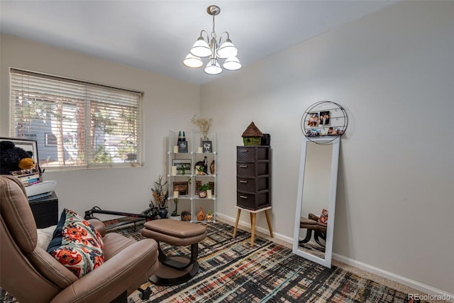 sitting room with carpet and an inviting chandelier