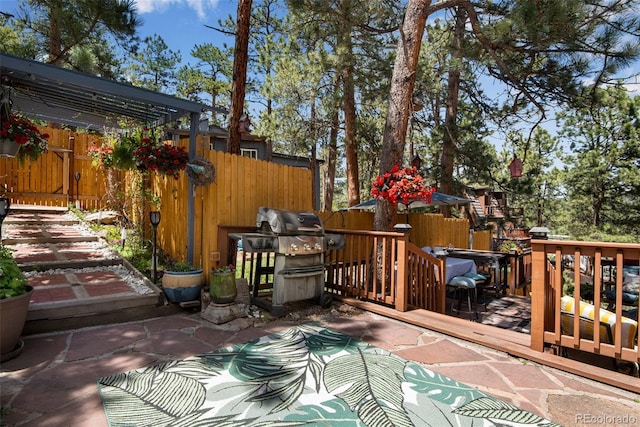 deck with grilling area and a pergola