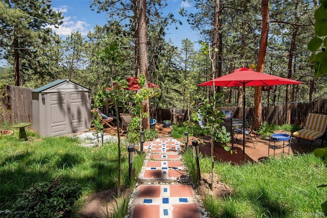 view of yard featuring a deck and a storage shed