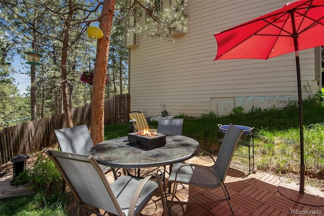 wooden deck featuring a patio area and an outdoor fire pit