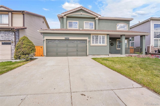 19731 E 40th Ave, Denver, CO 80249 - traditional-style house with stucco siding, driveway, a porch, and an attached garage
