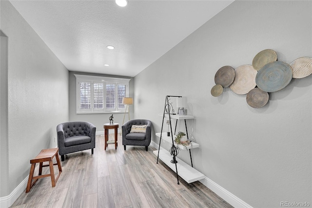 19731 E 40th Ave, Denver, CO 80249 - living area with light wood-style flooring, recessed lighting, and a textured ceiling
